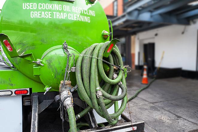 a technician pumping a grease trap in a commercial building in Studio City, CA